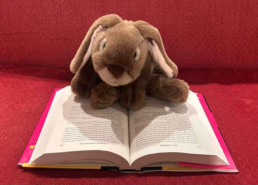 Caramel is reading Dungeon Crawler Carl by Matt Dinniman.