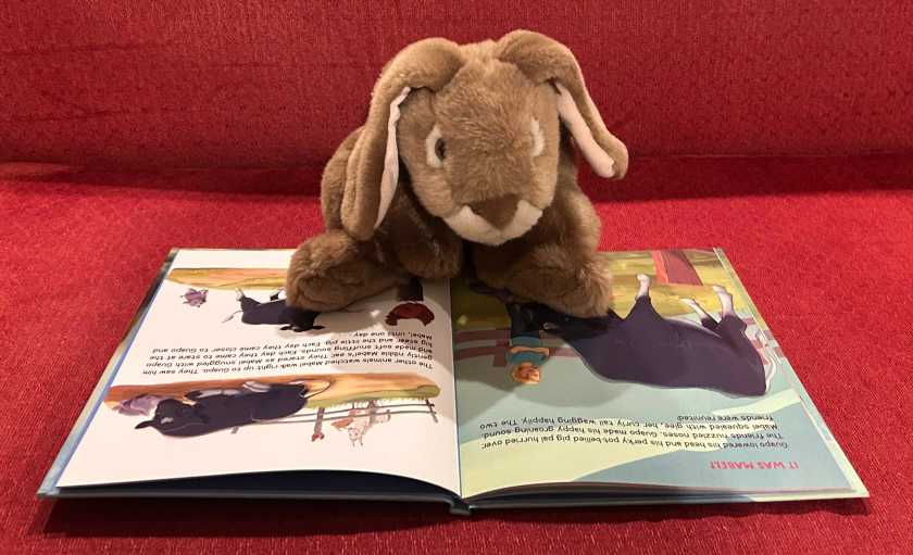Caramel is reading Guapo’s Giant Heart: The True Story of The Calf Who Kept Growing, written by Janet Zappala and Wendy Perkins, and illustrated by Lara Calleja.